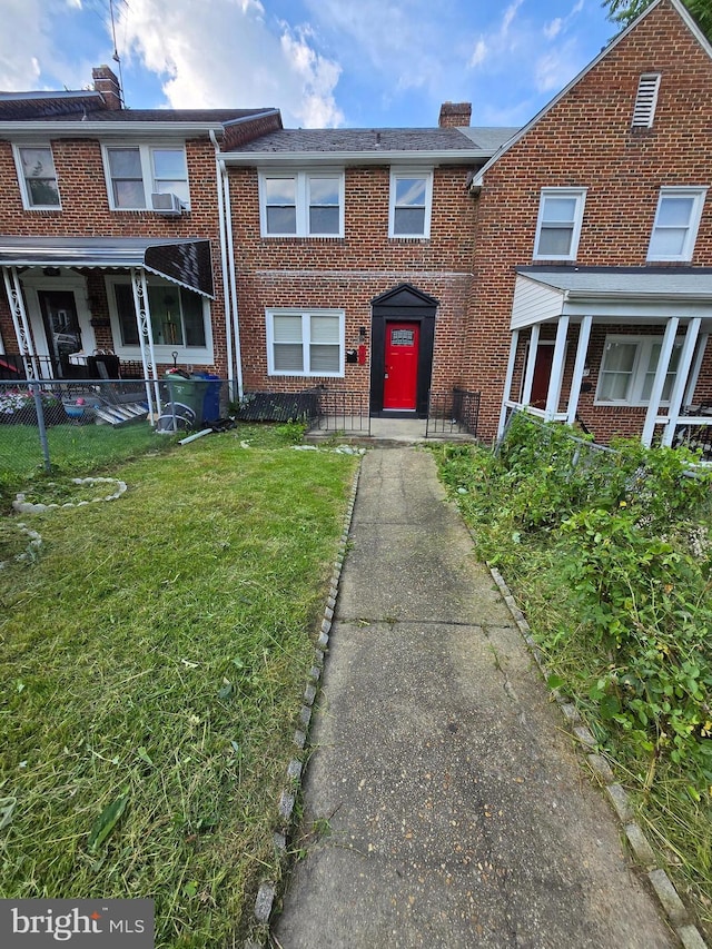 940 E 41st St, Baltimore, MD 21218 - view of property featuring brick siding and a chimney