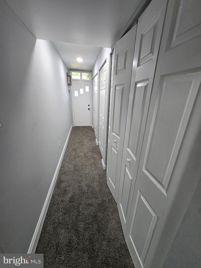 940 E 41st St, Baltimore, MD 21218 - corridor featuring dark colored carpet and baseboards