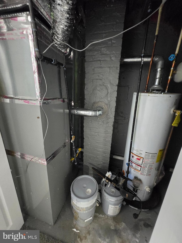 940 E 41st St, Baltimore, MD 21218 - utility room featuring water heater and heating unit
