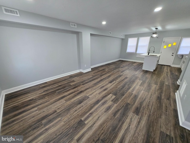 940 E 41st St, Baltimore, MD 21218 - unfurnished living room with dark wood-style floors and recessed lighting