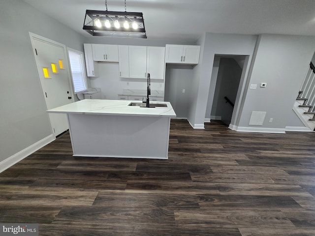 940 E 41st St, Baltimore, MD 21218 - kitchen with white cabinetry, a kitchen island with sink, and dark wood-style flooring