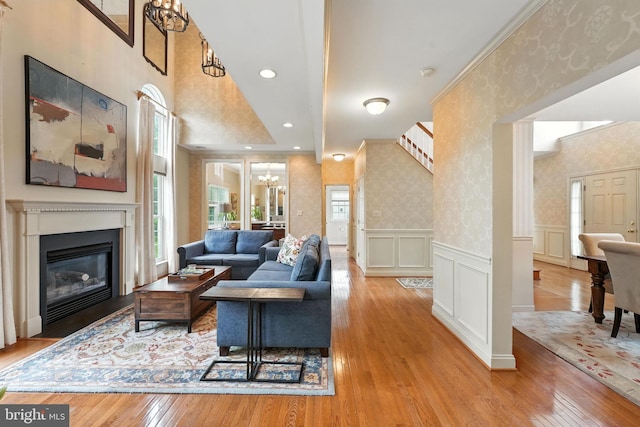 28 White Birch Blvd, Bear, DE 19701 - living area featuring plenty of natural light, a chandelier, wallpapered walls, hardwood / wood-style floors, and a fireplace with flush hearth