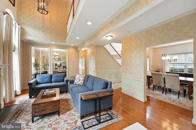 28 White Birch Blvd, Bear, DE 19701 - living area featuring a chandelier, hardwood / wood-style floors, wallpapered walls, ornamental molding, and stairs