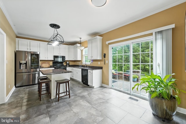 28 White Birch Blvd, Bear, DE 19701 - kitchen with black appliances, ornamental molding, dark countertops, white cabinets, and a center island