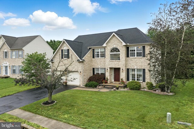 28 White Birch Blvd, Bear, DE 19701 - view of front of home featuring driveway, a front yard, an attached garage, and brick siding