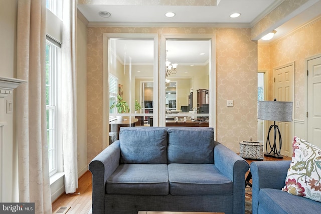 28 White Birch Blvd, Bear, DE 19701 - living area with wallpapered walls, wood finished floors, ornamental molding, and a chandelier