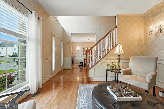 28 White Birch Blvd, Bear, DE 19701 - living area with wallpapered walls, stairs, light wood-type flooring, a wainscoted wall, and a decorative wall