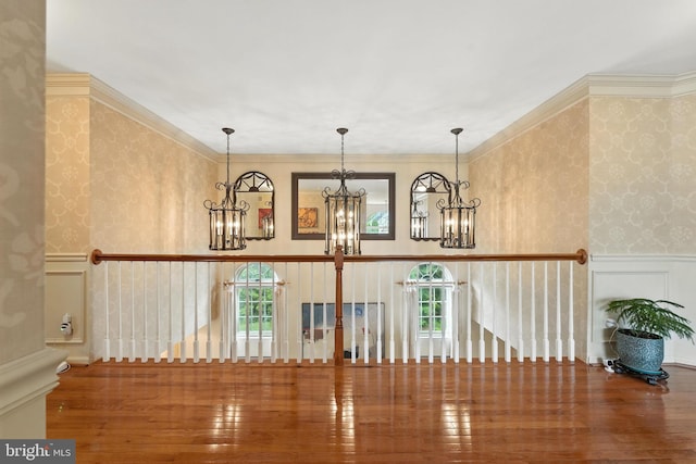 28 White Birch Blvd, Bear, DE 19701 - corridor with wallpapered walls, a chandelier, wood finished floors, wainscoting, and a decorative wall