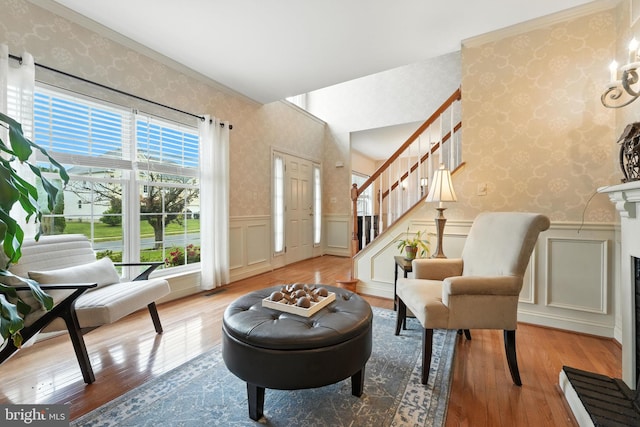 28 White Birch Blvd, Bear, DE 19701 - living area featuring wallpapered walls, hardwood / wood-style floors, stairs, a decorative wall, and a wainscoted wall
