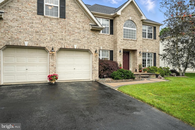 28 White Birch Blvd, Bear, DE 19701 - view of front of property featuring driveway, a front yard, brick siding, and an attached garage