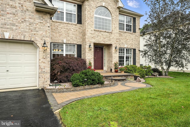 28 White Birch Blvd, Bear, DE 19701 - view of front of property featuring a garage, a front yard, brick siding, and asphalt driveway