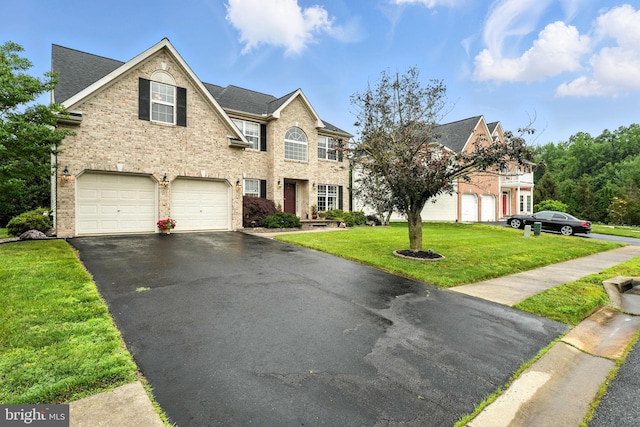 28 White Birch Blvd, Bear, DE 19701 - view of front facade featuring an attached garage, asphalt driveway, a front lawn, roof with shingles, and brick siding