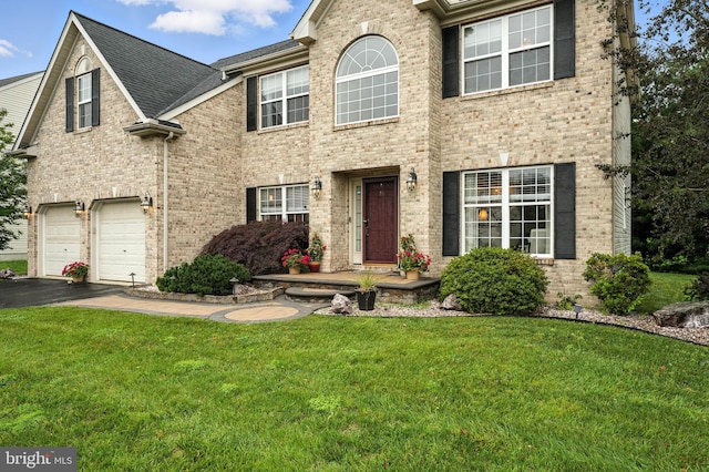 28 White Birch Blvd, Bear, DE 19701 - view of front of home featuring brick siding, a front yard, a garage, and driveway