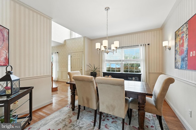 28 White Birch Blvd, Bear, DE 19701 - dining area featuring a chandelier, wallpapered walls, and wood finished floors