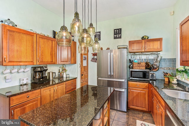 125 N Hanover St, Pottstown, PA 19464 - kitchen featuring stainless steel appliances, brown cabinetry, and tasteful backsplash