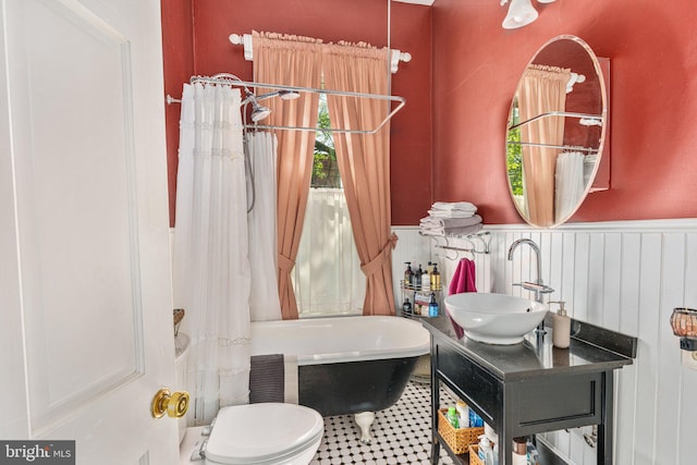 125 N Hanover St, Pottstown, PA 19464 - full bathroom with wainscoting, a freestanding bath, and vanity