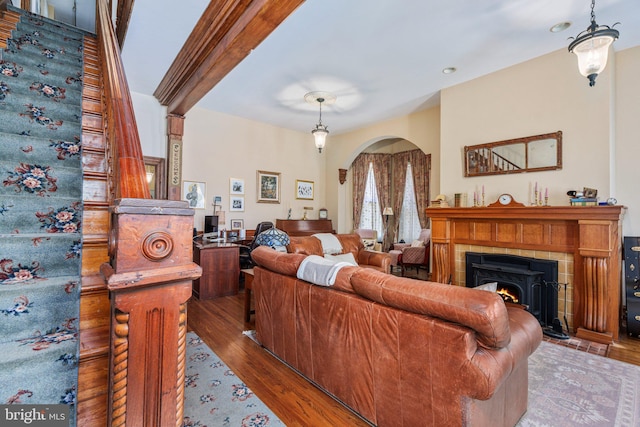 125 N Hanover St, Pottstown, PA 19464 - living room featuring arched walkways, wood finished floors, and a tile fireplace