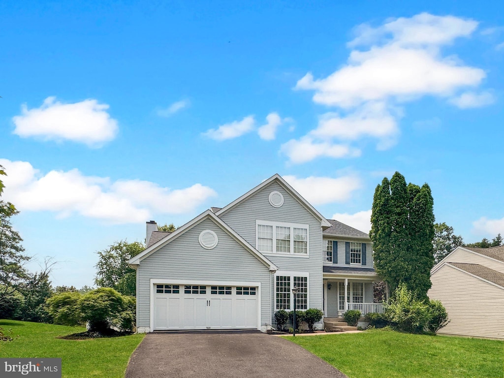9659 Allegro Dr, Manassas, VA 20112 - traditional-style home with covered porch, a front lawn, driveway, and a chimney