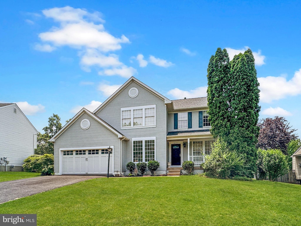 9659 Allegro Dr, Manassas, VA 20112 - traditional-style home featuring driveway, a front yard, a porch, and a garage
