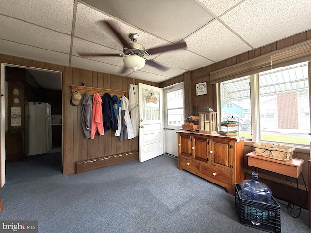 619 Penn Dr, Tamaqua, PA 18252 - carpeted bedroom featuring a drop ceiling, wooden walls, a closet, freestanding refrigerator, and ceiling fan