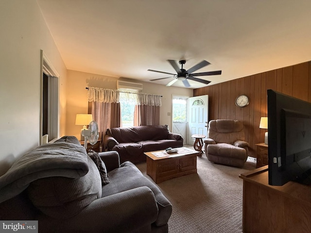 619 Penn Dr, Tamaqua, PA 18252 - carpeted living area featuring a wall unit AC, wood walls, and a ceiling fan
