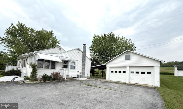 619 Penn Dr, Tamaqua, PA 18252 - view of front of property featuring an outdoor structure, a chimney, a front lawn, and a garage