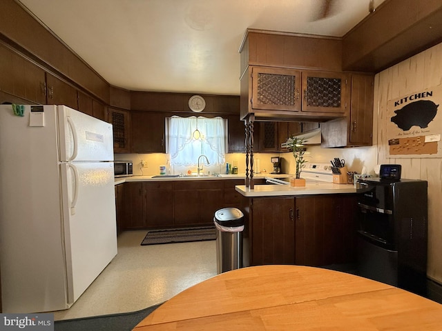 619 Penn Dr, Tamaqua, PA 18252 - kitchen with freestanding refrigerator, light countertops, dark brown cabinets, stainless steel microwave, and under cabinet range hood