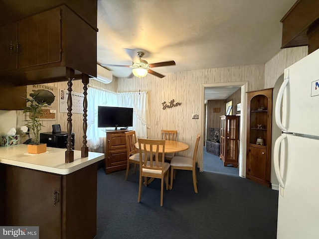 619 Penn Dr, Tamaqua, PA 18252 - dining room featuring ceiling fan, dark carpet, and wooden walls