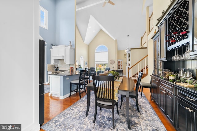 336 Lincoln Rd, Pilesgrove, NJ 08098 - dining area featuring high vaulted ceiling, wood finished floors, stairs, beam ceiling, and ceiling fan