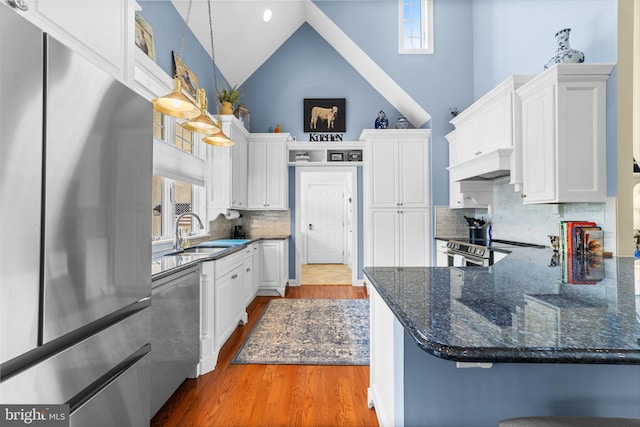 336 Lincoln Rd, Pilesgrove, NJ 08098 - kitchen with stainless steel appliances, white cabinetry, wood finished floors, high vaulted ceiling, and custom range hood