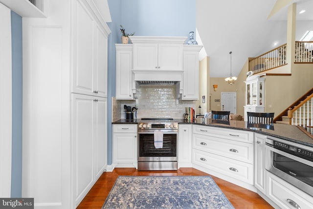 336 Lincoln Rd, Pilesgrove, NJ 08098 - kitchen featuring stainless steel range with electric cooktop, backsplash, white cabinetry, dark wood-type flooring, and vaulted ceiling