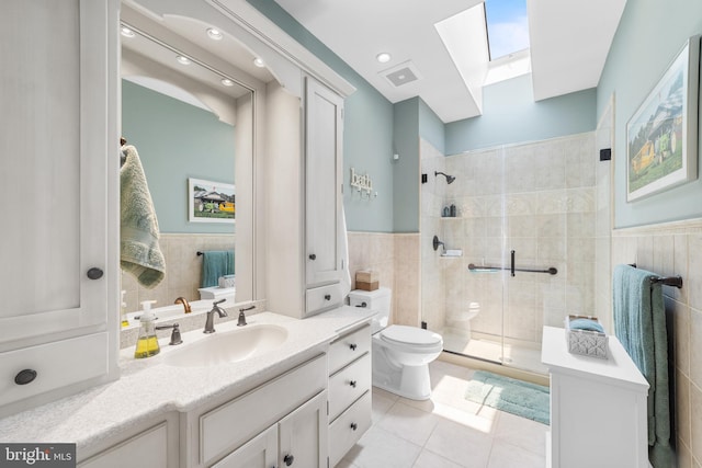 336 Lincoln Rd, Pilesgrove, NJ 08098 - bathroom featuring a skylight, tile walls, a shower stall, tile patterned floors, and vanity