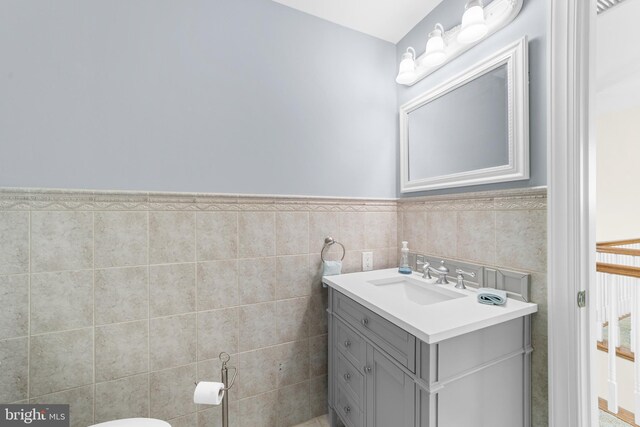 336 Lincoln Rd, Pilesgrove, NJ 08098 - half bath with vanity, a wainscoted wall, and tile walls