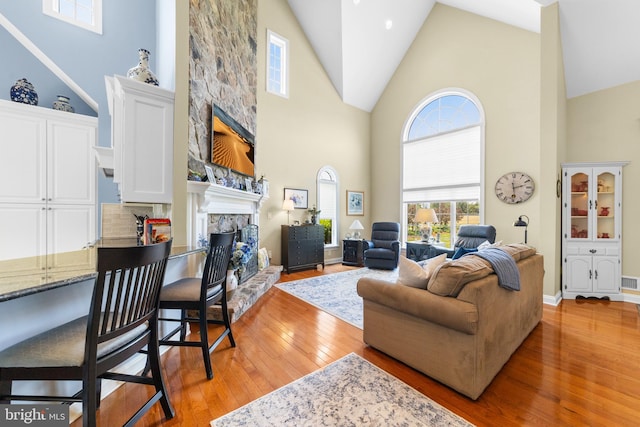 336 Lincoln Rd, Pilesgrove, NJ 08098 - living room with a stone fireplace, high vaulted ceiling, and light wood finished floors