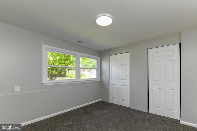 754 Second St, Woodbury Heights, NJ 08097 - unfurnished bedroom featuring dark carpet and multiple closets