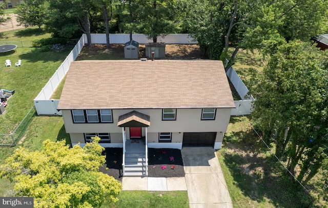 754 Second St, Woodbury Heights, NJ 08097 - view of front of house featuring a garage, concrete driveway, a storage unit, stairs, and a fenced backyard
