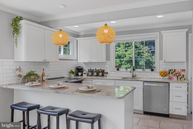 1305 Heather Hill Rd, Baltimore, MD 21239 - kitchen with appliances with stainless steel finishes, white cabinetry, a kitchen bar, a peninsula, and tasteful backsplash