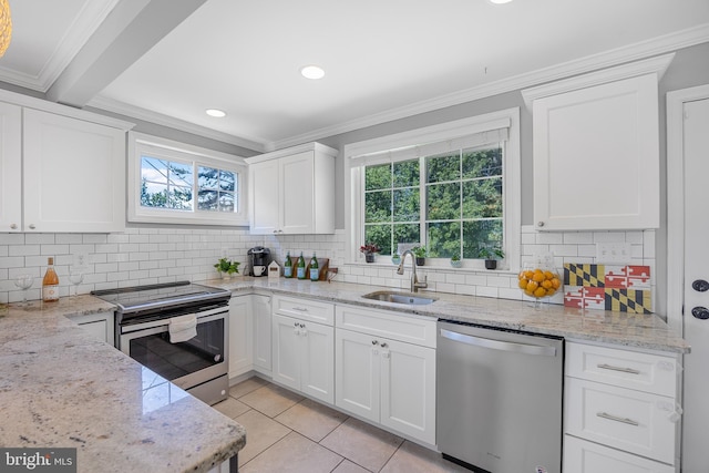 1305 Heather Hill Rd, Baltimore, MD 21239 - kitchen featuring stainless steel appliances, crown molding, decorative backsplash, white cabinets, and recessed lighting