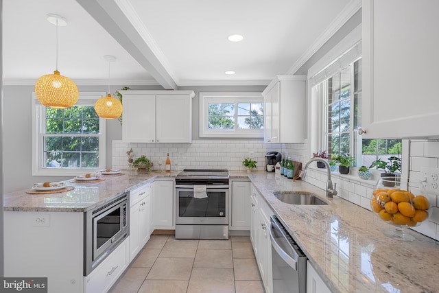 1305 Heather Hill Rd, Baltimore, MD 21239 - kitchen featuring stainless steel appliances, crown molding, white cabinetry, a peninsula, and light tile patterned floors