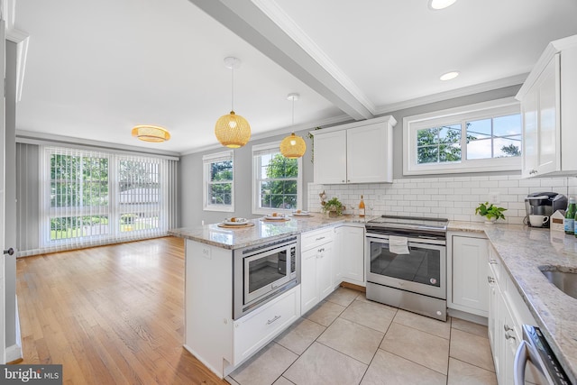 1305 Heather Hill Rd, Baltimore, MD 21239 - kitchen featuring stainless steel appliances, crown molding, a peninsula, white cabinetry, and tasteful backsplash