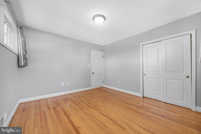 1305 Heather Hill Rd, Baltimore, MD 21239 - unfurnished bedroom with light wood finished floors and a closet