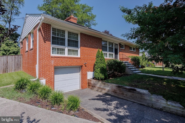 1305 Heather Hill Rd, Baltimore, MD 21239 - view of front of house featuring brick siding, asphalt driveway, an attached garage, and a chimney