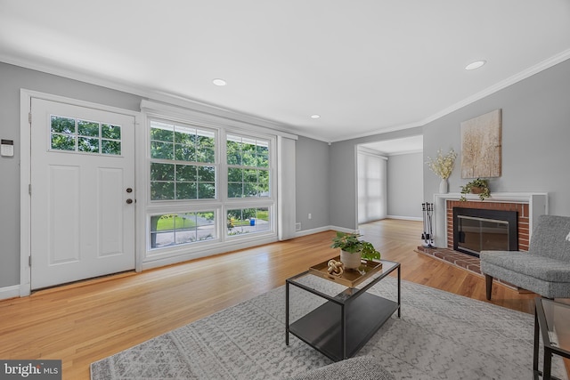 1305 Heather Hill Rd, Baltimore, MD 21239 - living area featuring crown molding, wood finished floors, a fireplace, and recessed lighting