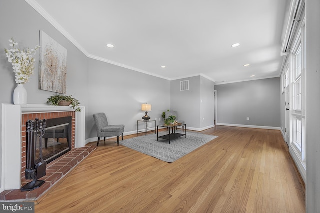 1305 Heather Hill Rd, Baltimore, MD 21239 - sitting room featuring wood finished floors, ornamental molding, recessed lighting, a brick fireplace, and plenty of natural light