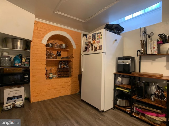 316-322 W Wildey St, Philadelphia, PA 19123 - kitchen featuring freestanding refrigerator, wood finished floors, black microwave, brick wall, and crown molding