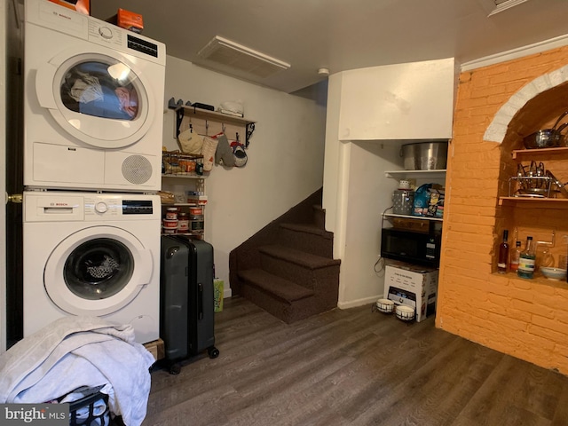 316-322 W Wildey St, Philadelphia, PA 19123 - laundry room featuring stacked washer and clothes dryer, dark wood-style flooring, and brick wall