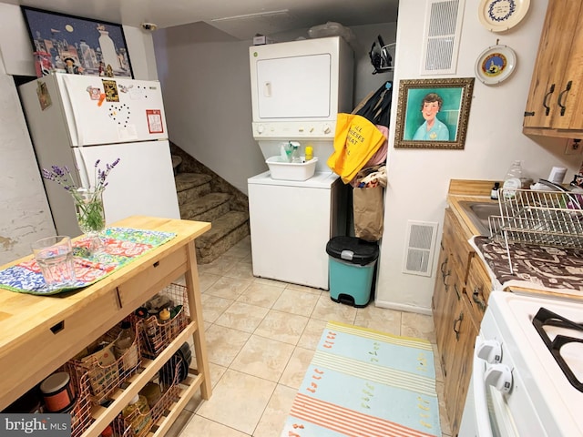 316-322 W Wildey St, Philadelphia, PA 19123 - kitchen with white appliances, stacked washer / dryer, and light tile patterned flooring