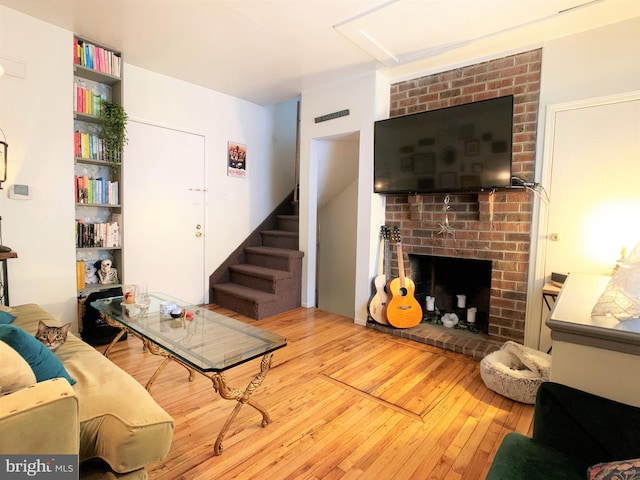 316-322 W Wildey St, Philadelphia, PA 19123 - living area with hardwood / wood-style floors, a brick fireplace, stairs, and attic access