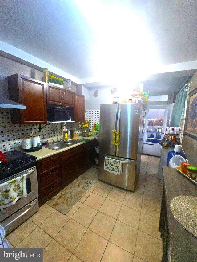 458 W Oley St, Reading, PA 19601 - kitchen featuring appliances with stainless steel finishes, light tile patterned floors, backsplash, and light countertops