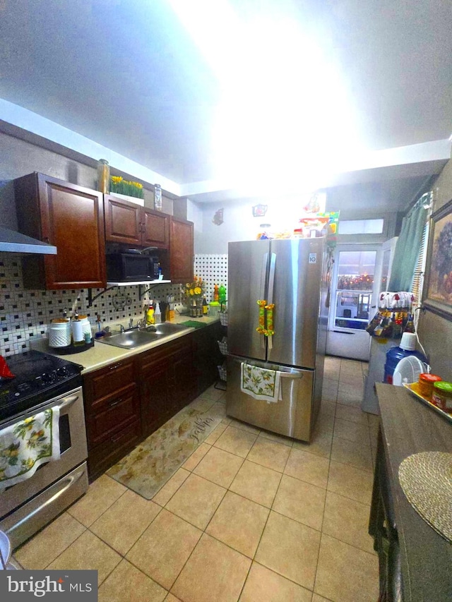 458 W Oley St, Reading, PA 19601 - kitchen with appliances with stainless steel finishes, backsplash, light tile patterned floors, and light countertops